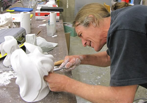A Sculpter works on a small sculpture